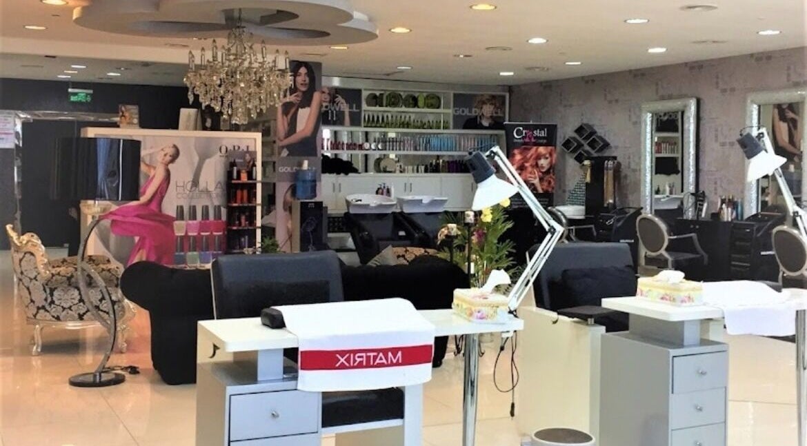 Interior view of Crystal Beauty Lounge in Dubai, AE, featuring stylish salon stations and decor.