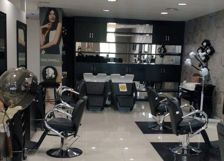 Modern interior of Crystal Beauty Lounge salon in Dubai, AE with sleek styling chairs and equipment.