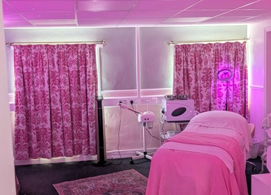 Cozy treatment room at Skinfit Studio, Shifnal, England, GB with pink decor and wellness equipment.