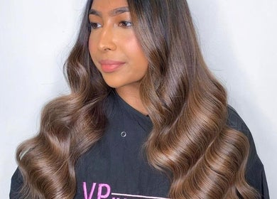 Stylish waves hairstyle at VP Hair Art Co Sutton, Birmingham, England, GB. Highlighting sleek, shiny hair.
