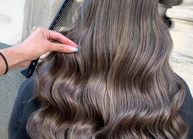 Elegant wavy hairstyle crafted at VP Hair Art Co Sutton in Birmingham, England, GB, showcasing sleek, glossy locks.