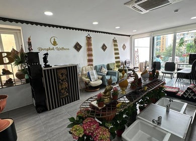Interior of Bangkok Wellness, St. Julian's, MT, showcasing cozy seating with cultural decor and natural light.