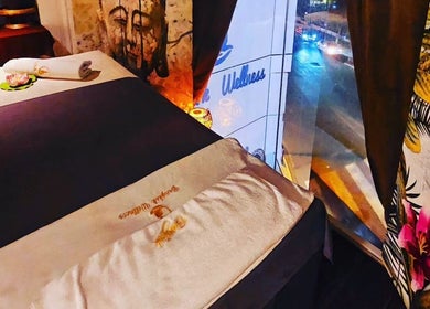 Relaxing massage bed setup at Bangkok Wellness, St. Julian's, MT, overlooking street view at night.