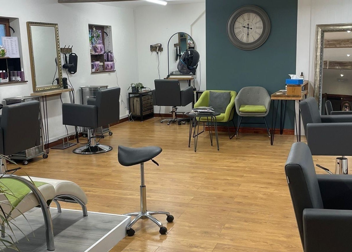 Modern interior of Dovecote Hair Studio (Ice) in Oxford, England, GB with stylish chairs and mirrors.