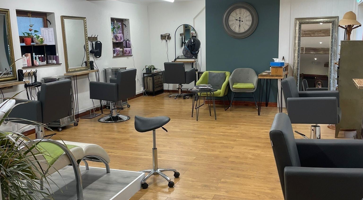 Modern interior of Dovecote Hair Studio (Ice) in Oxford, England, GB with stylish chairs and mirrors.