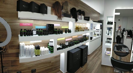 Interno di Montenero Hairstylist a Pescara, Abruzzo, IT con prodotti per capelli su scaffali eleganti.