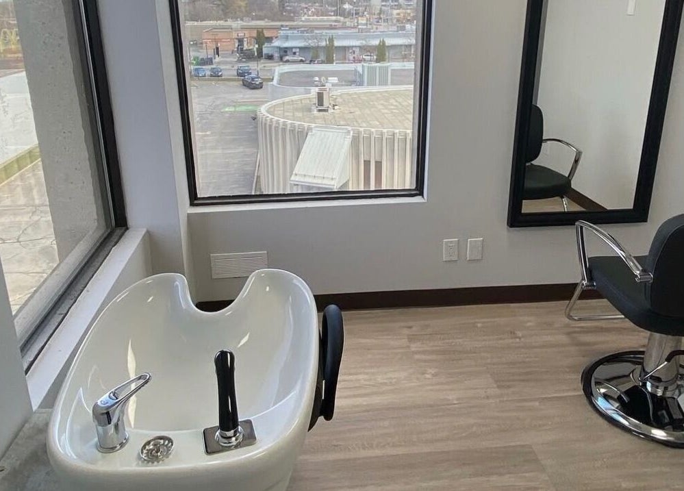 Elegant salon chair and washbasin at Kurlessence, Ottawa, Ontario, CA, providing a relaxing experience.