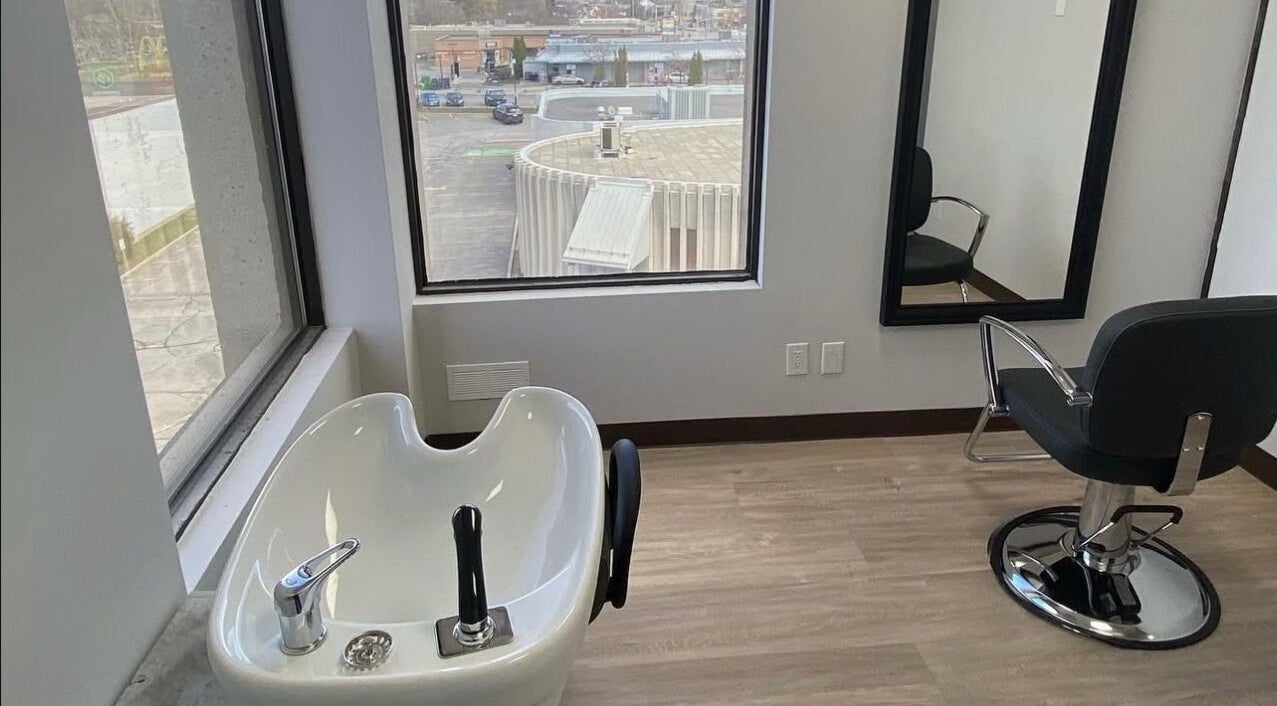 Elegant salon chair and washbasin at Kurlessence, Ottawa, Ontario, CA, providing a relaxing experience.