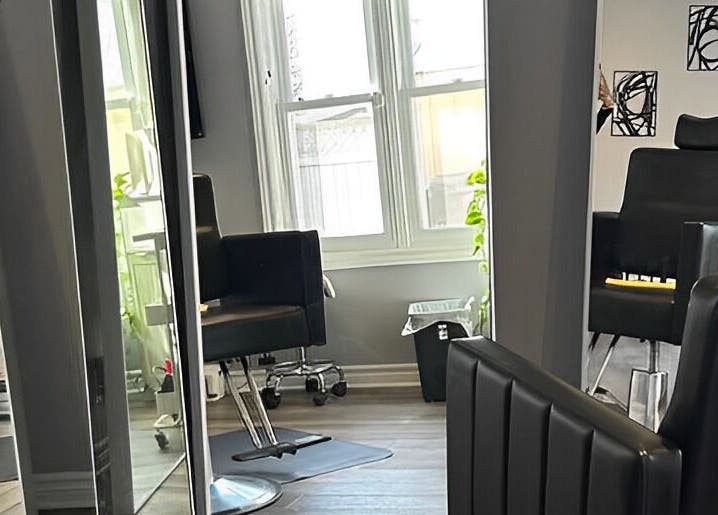 Modern salon chairs and mirrors at Kurlessence, Ottawa, Ontario, CA offering a sleek beauty experience.