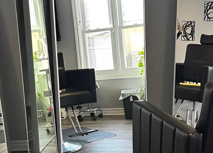 Modern salon chairs and mirrors at Kurlessence, Ottawa, Ontario, CA offering a sleek beauty experience.