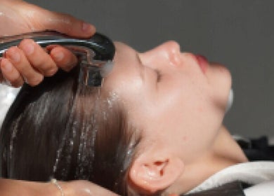 Hair care service at Hair Salon in Pererenan — Rasa Gaya, Bali, Bali, ID with woman receiving hair rinse.