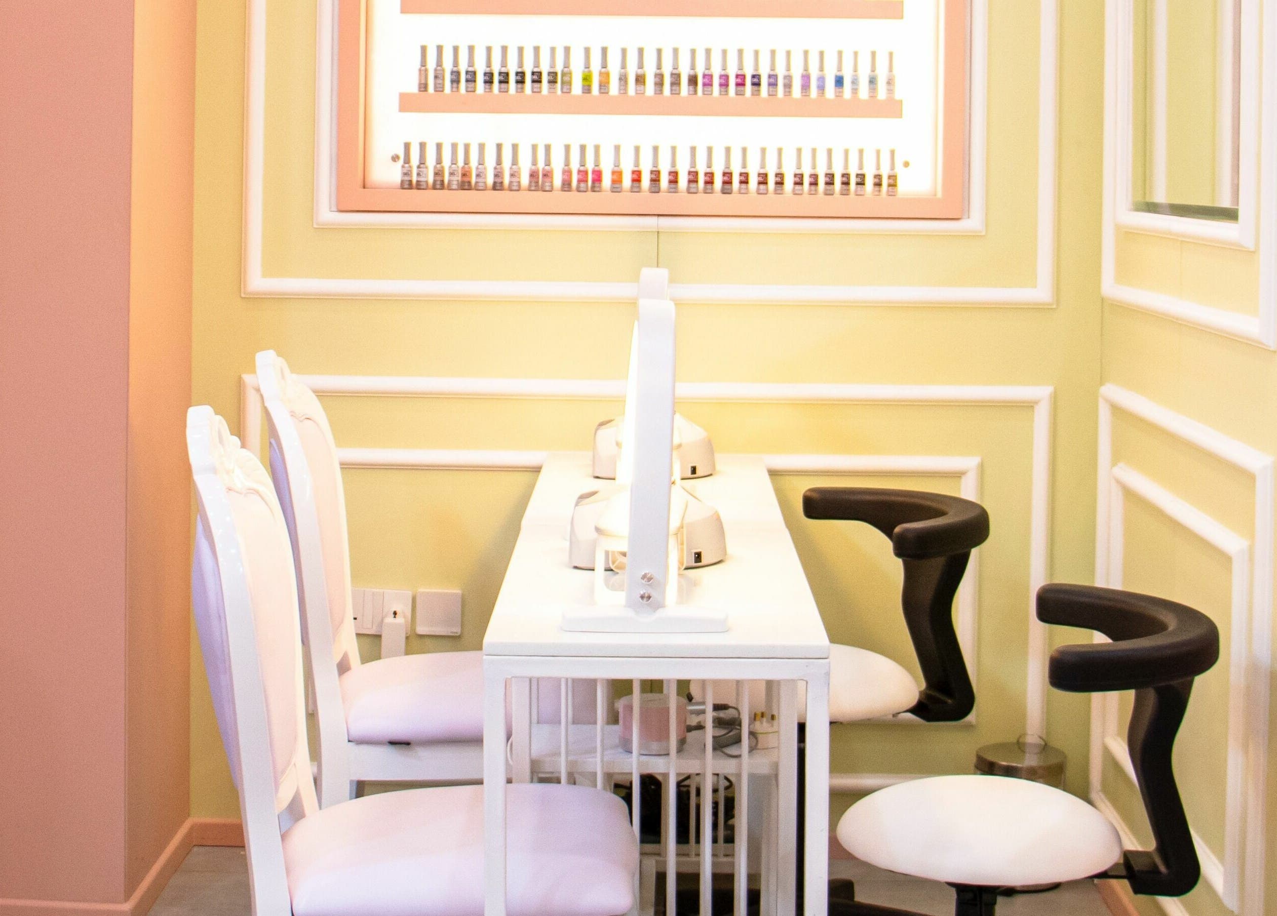 Chic nail bar at UB Beauty, Dubai, دبي, AE, featuring stylish seating and nail polish display.