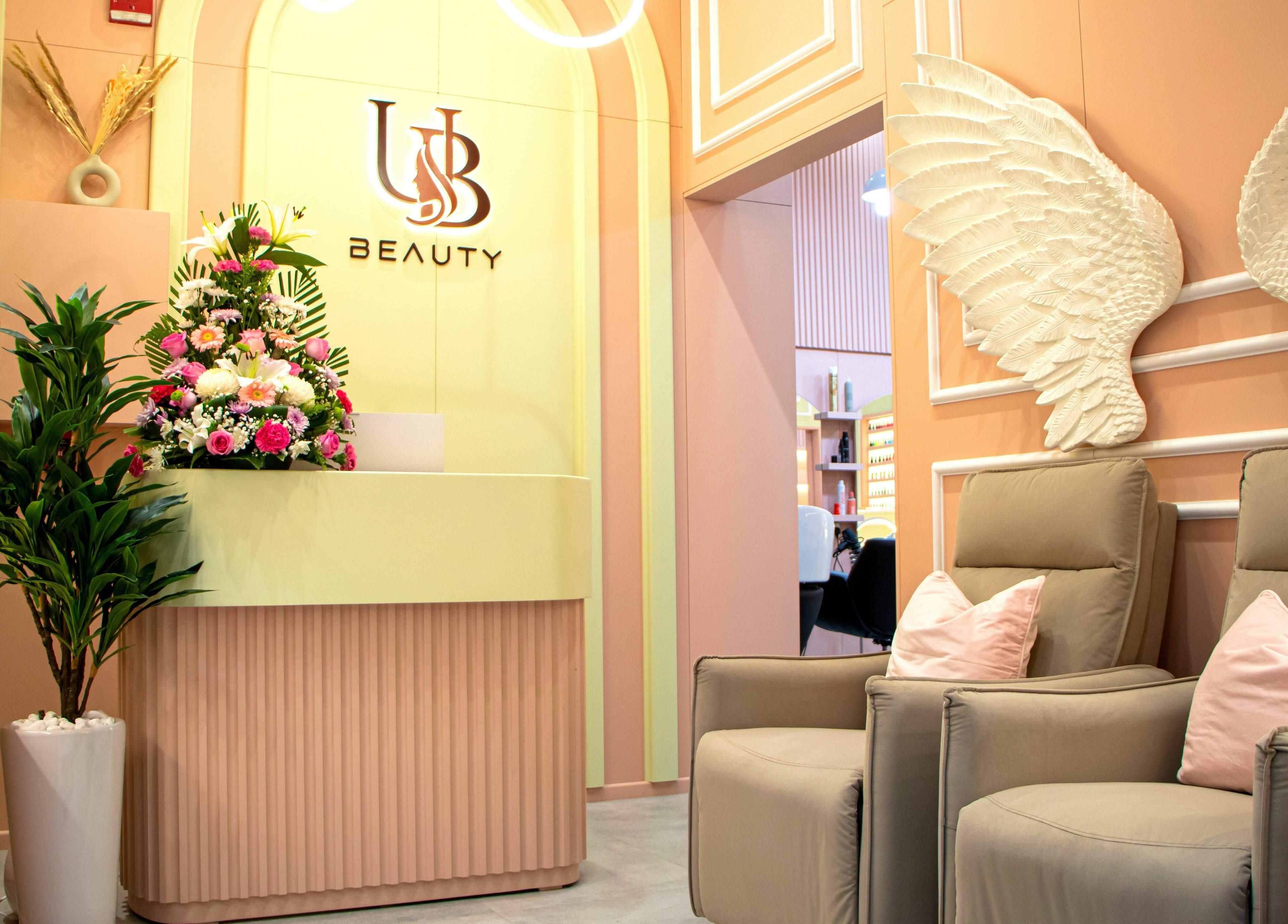 Chic UB Beauty reception area in Dubai, دبي, AE with floral decor and plush seating.