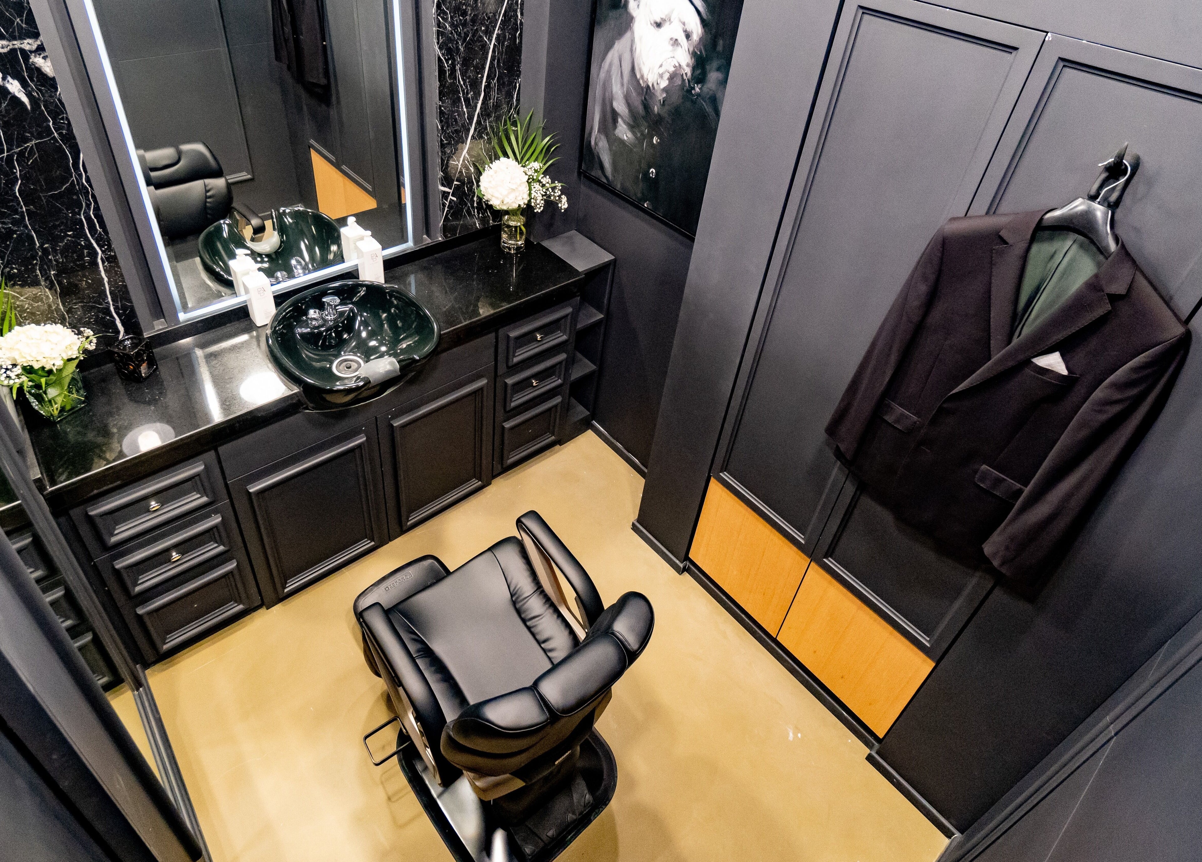 Sophisticated grooming space at UB Grooming Salon Ltd. DIFC, Dubai, AE featuring sleek black decor and barber chair.
