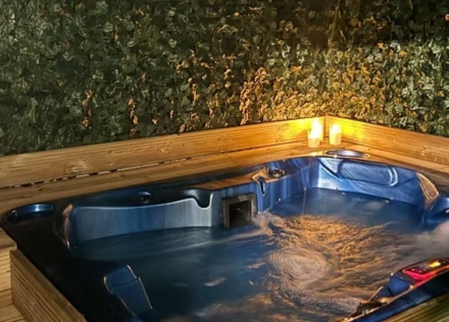 Luxurious hot tub with candles at Beauty of the Soul Spa Health and Beauty, Dumbarton, Scotland, GB.