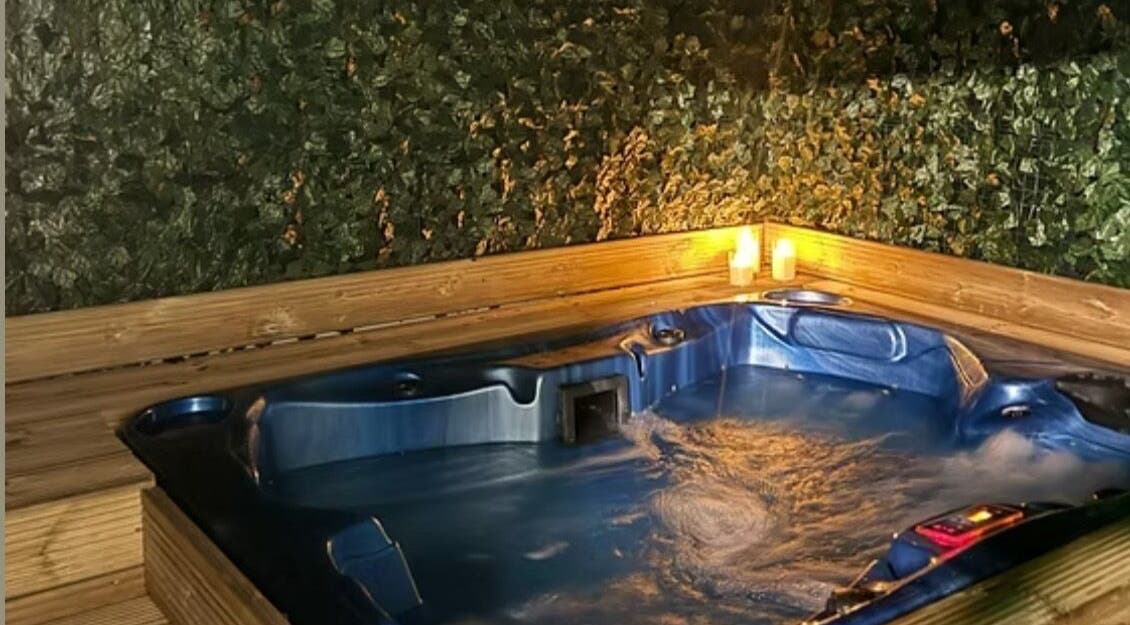 Luxurious hot tub with candles at Beauty of the Soul Spa Health and Beauty, Dumbarton, Scotland, GB.