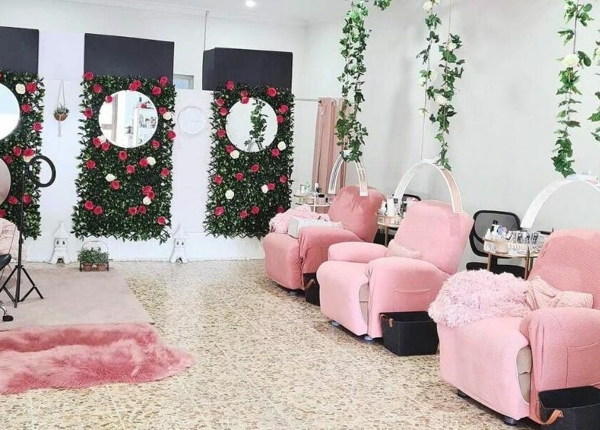 Relaxing space with pink chairs and floral decor at The Seven Great Lashes, Melbourne, Victoria, AU.