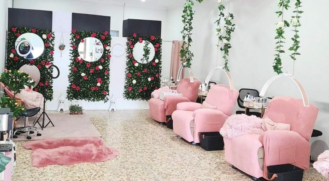 Relaxing space with pink chairs and floral decor at The Seven Great Lashes, Melbourne, Victoria, AU.