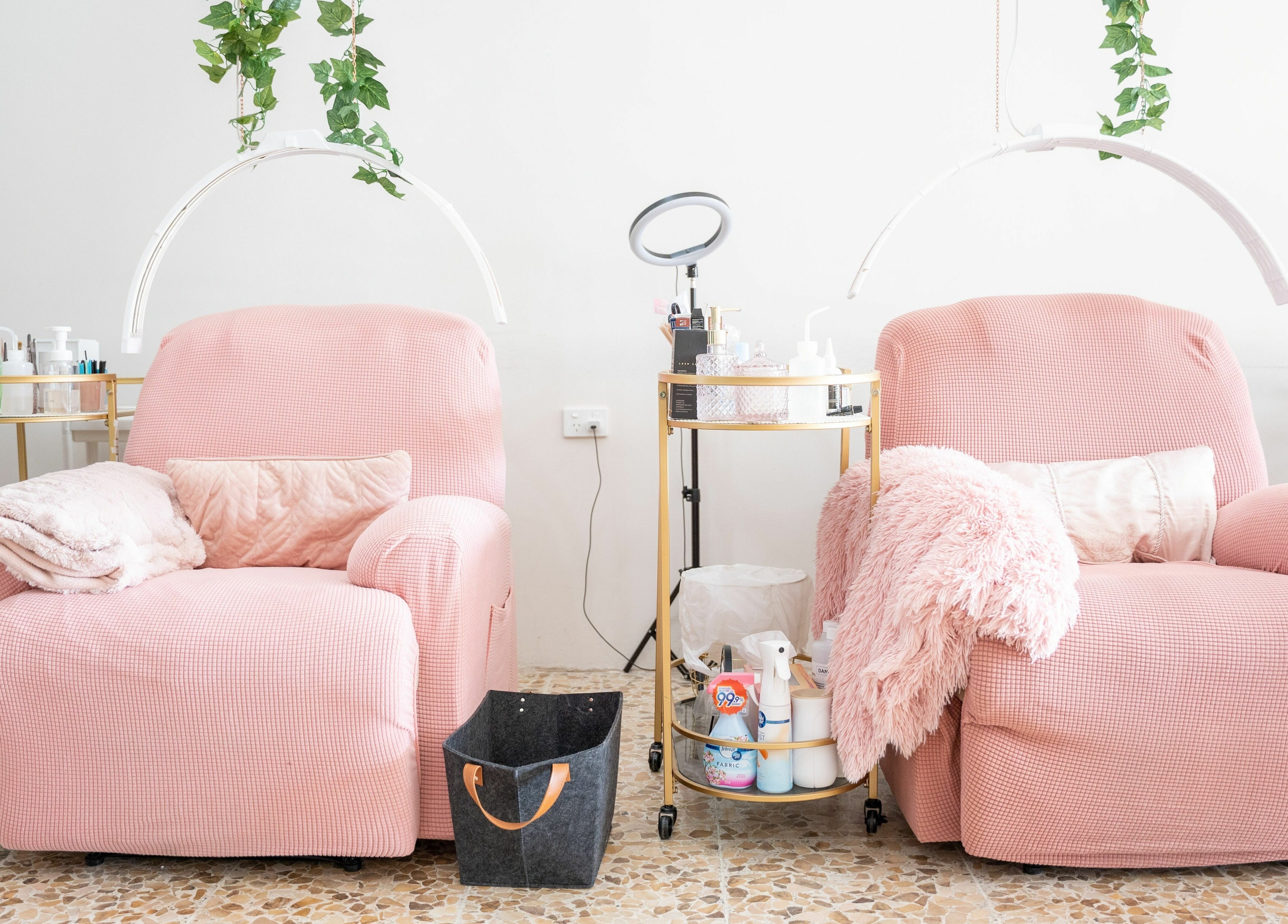Comfortable pink seating at The Seven Great Lashes in Melbourne, Victoria, AU, with plush blankets and beauty tools.
