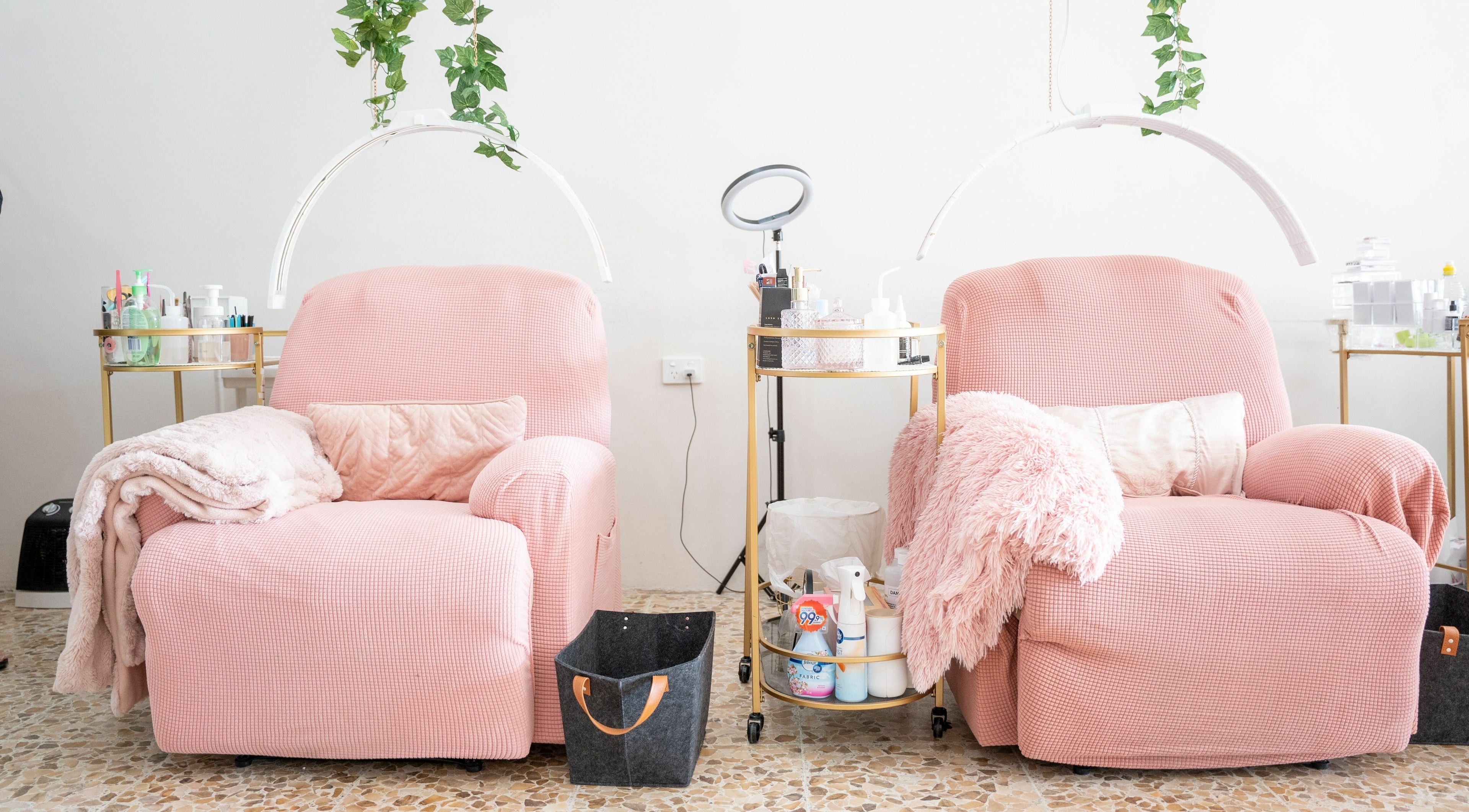 Comfortable pink seating at The Seven Great Lashes in Melbourne, Victoria, AU, with plush blankets and beauty tools.