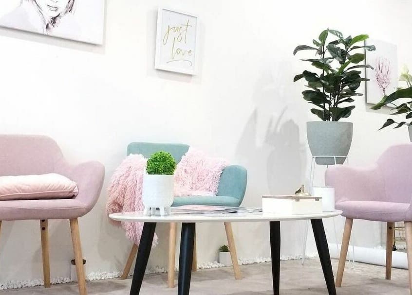 Elegant seating area at The Seven Great Lashes, Melbourne, Victoria, AU with pastel chairs and plants.
