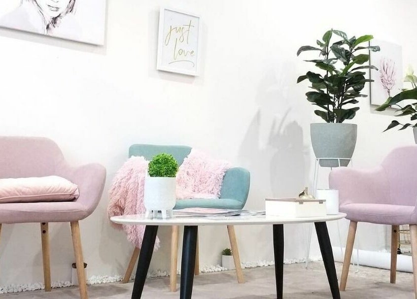 Elegant seating area at The Seven Great Lashes, Melbourne, Victoria, AU with pastel chairs and plants.