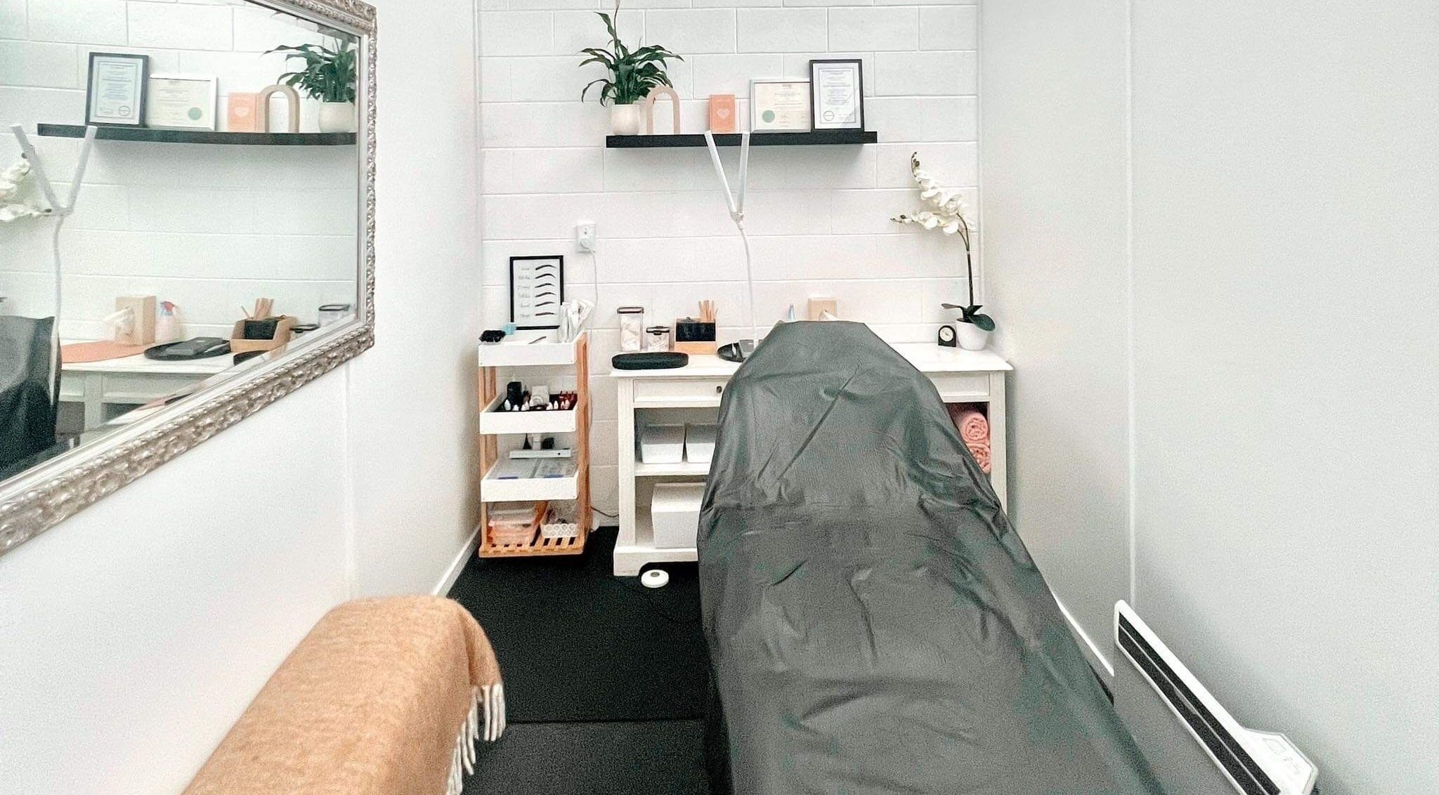 Massage room at Red Laser Beauty, Christchurch, Canterbury, NZ showcasing a calming ambiance with modern decor.