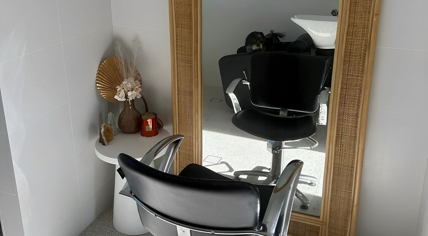 Hair salon chair and mirror at El J & Co on Ellis Lane, New South Wales, AU, showcasing chic floral decor.