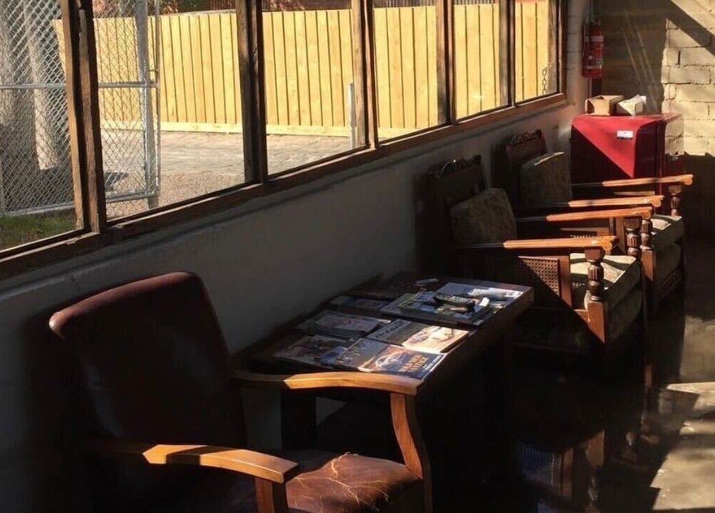 Roy's Barber waiting area with plush chairs and magazines, Melbourne, Victoria, AU.
