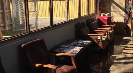 Roy's Barber waiting area with plush chairs and magazines, Melbourne, Victoria, AU.