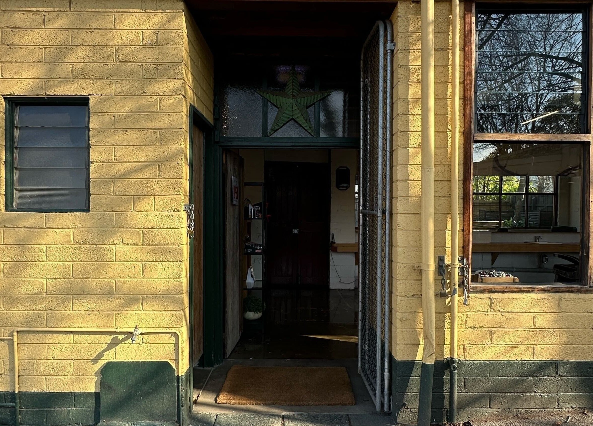 Entrance of Roy's Barber in Melbourne, Victoria, AU, with a welcoming vintage exterior.