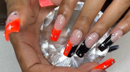 Elegant nail art at Nail Couture Cave Creek, Cave Creek, Arizona, US, featuring red and black ombre with rhinestones.