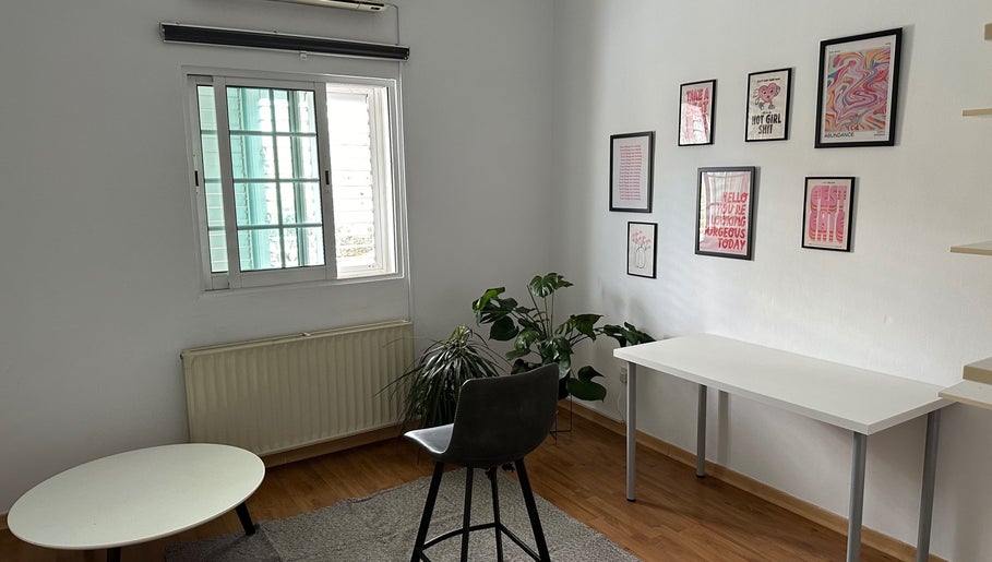 Bright interior of Makeup by Evi K, Agios Dometios, Nicosia, CY, featuring modern decor and lush green plants.