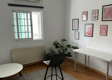 Bright interior of Makeup by Evi K, Agios Dometios, Nicosia, CY, featuring modern decor and lush green plants.