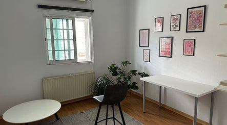 Bright interior of Makeup by Evi K, Agios Dometios, Nicosia, CY, featuring modern decor and lush green plants.