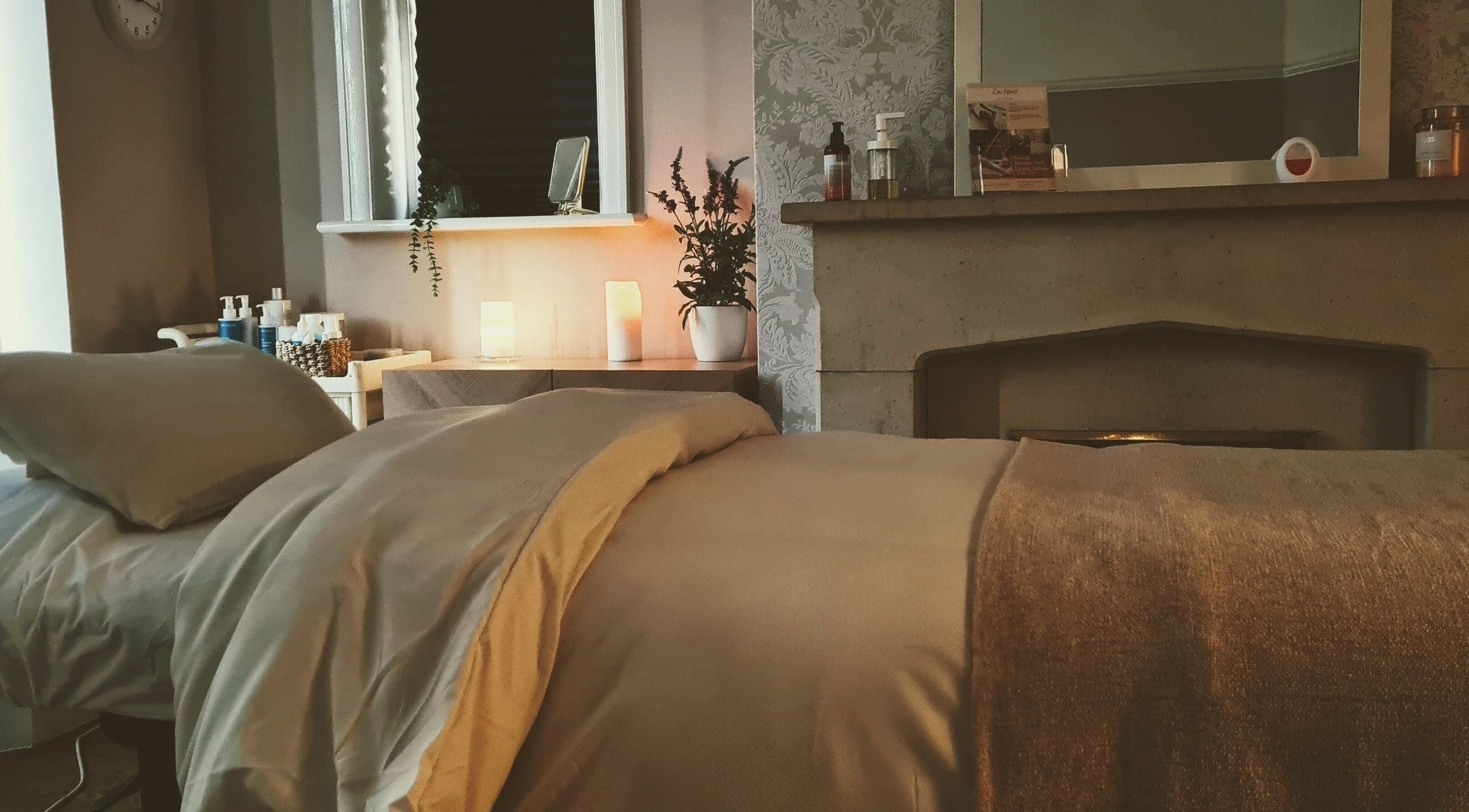 Peaceful treatment room at Lou Spicer Beauty Therapy, Poole, England, GB, with cozy bed and calming decor.