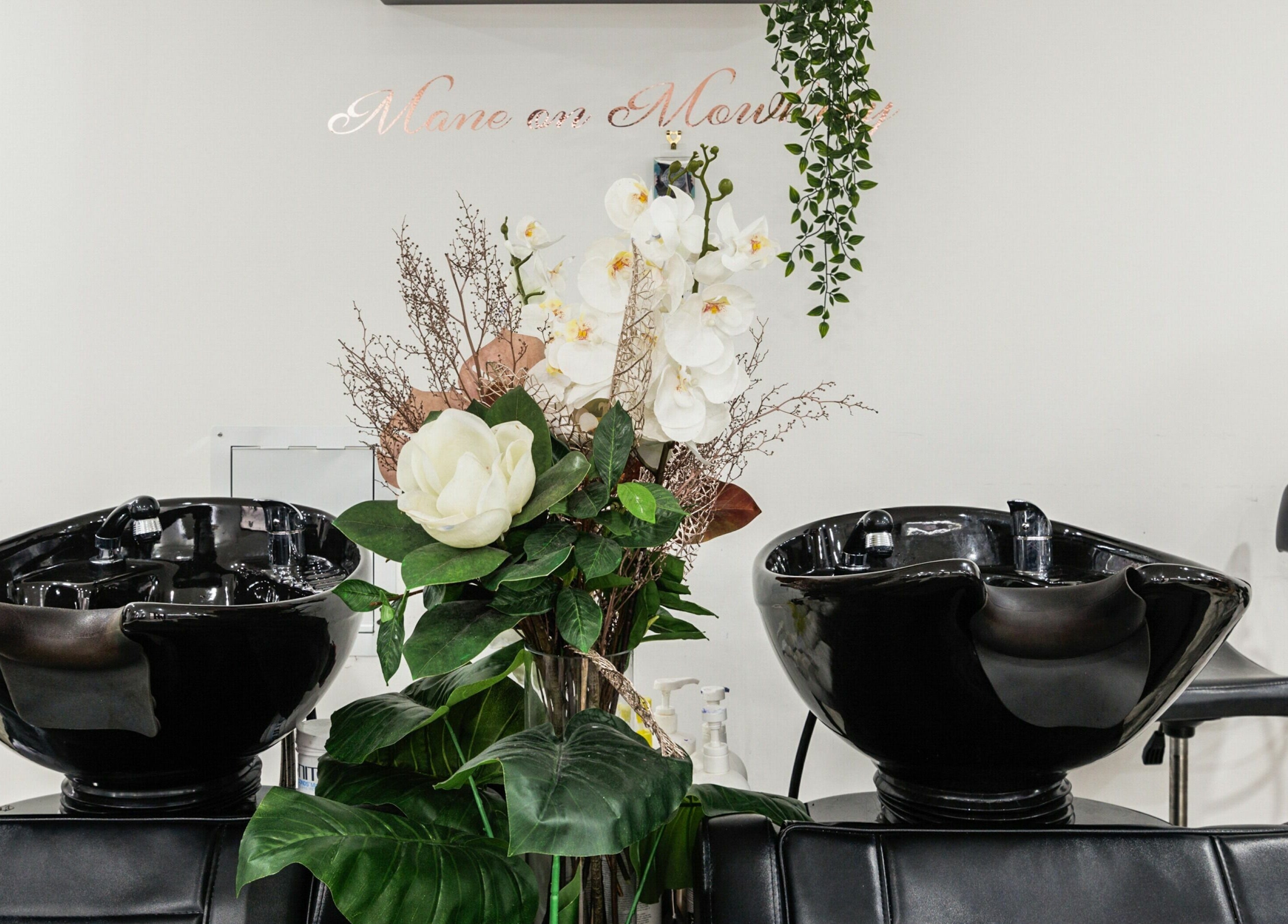 Stylish shampoo stations and floral display at Mane On Mowbray, East Brisbane, Queensland, AU.