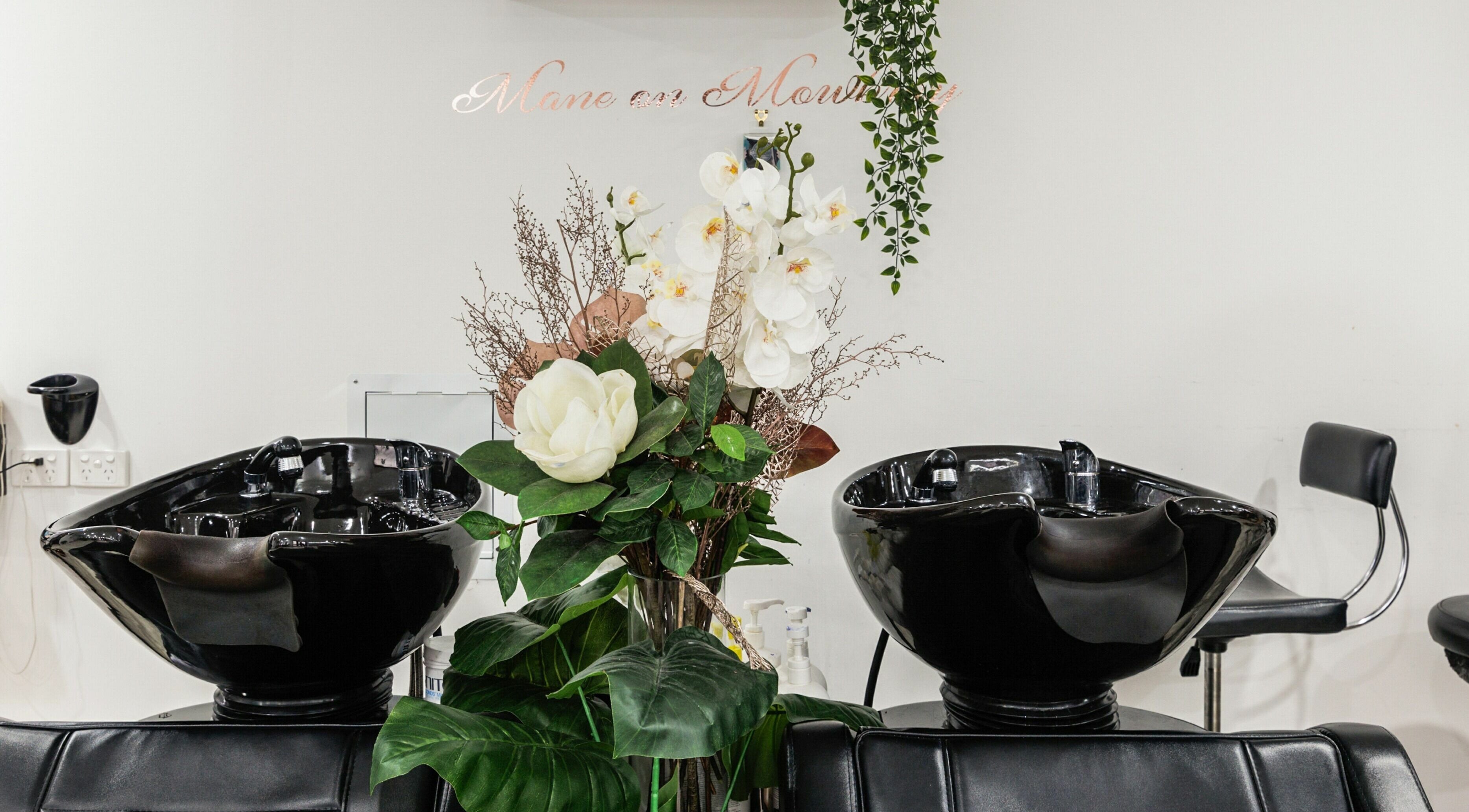Stylish shampoo stations and floral display at Mane On Mowbray, East Brisbane, Queensland, AU.