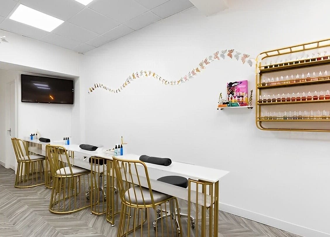 Elegant nail salon at Chocolate & Nails - Northfield, London, England, GB with sleek decor and gold-accented chairs.