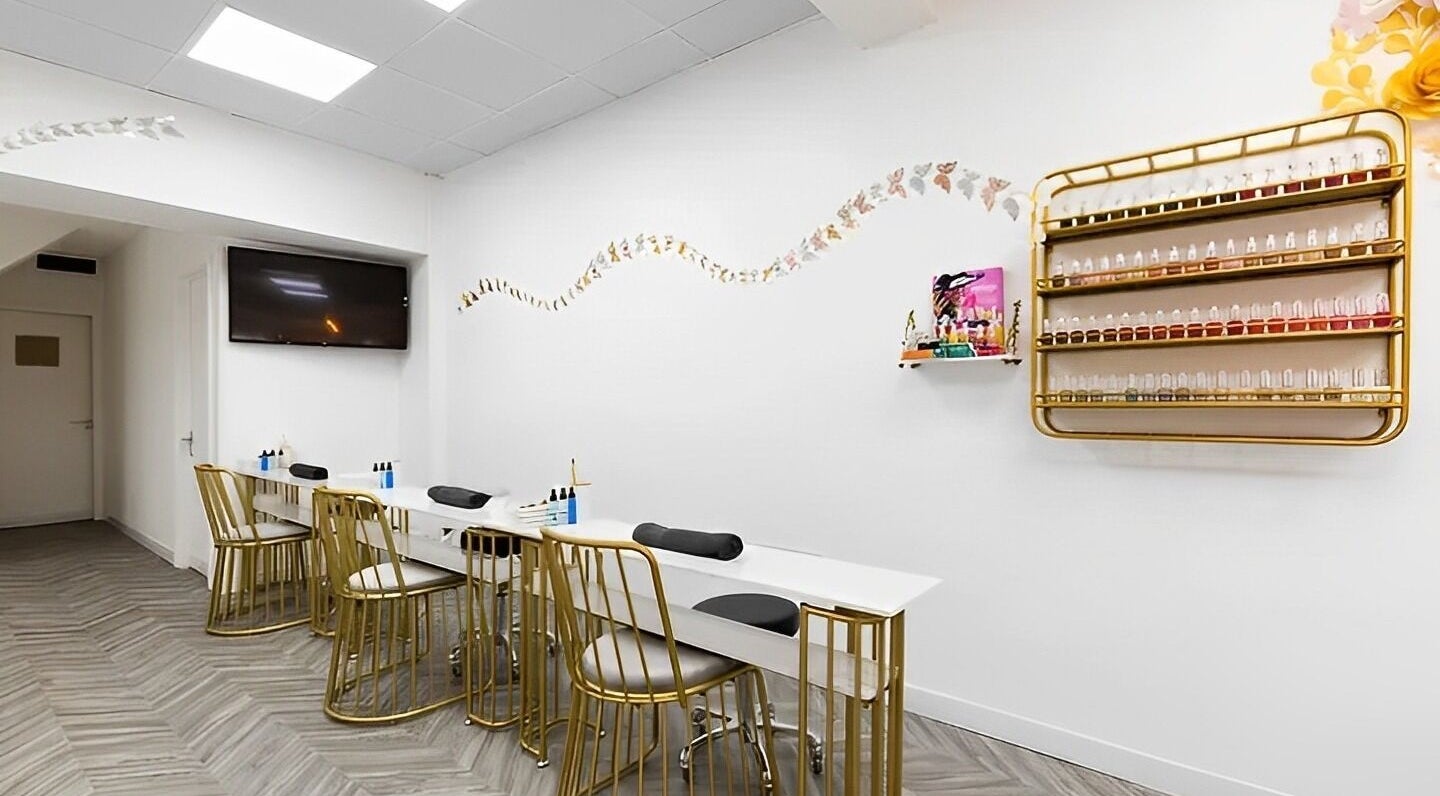 Elegant nail salon at Chocolate & Nails - Northfield, London, England, GB with sleek decor and gold-accented chairs.
