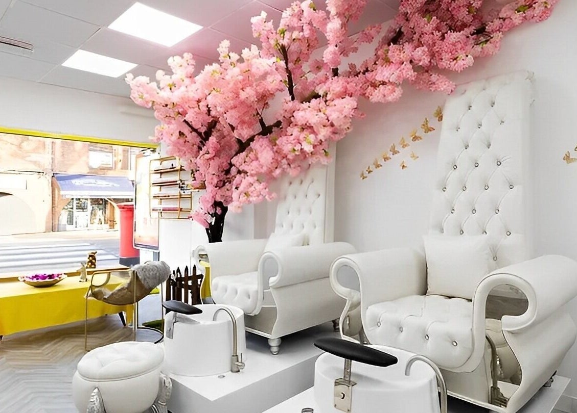 Luxurious pedicure chairs under cherry blossoms at Chocolate & Nails - Northfield, London, England, GB.