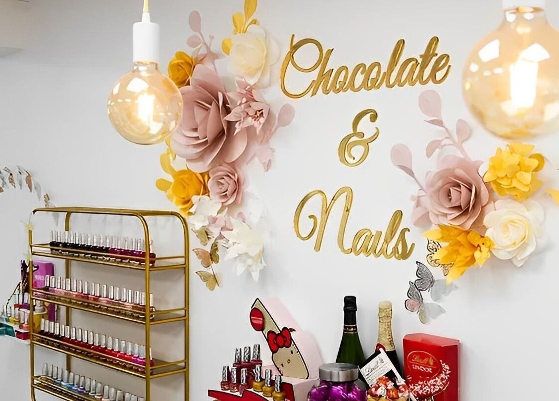 Interior of Chocolate & Nails - Northfield, London, with nail polish and chic decor.