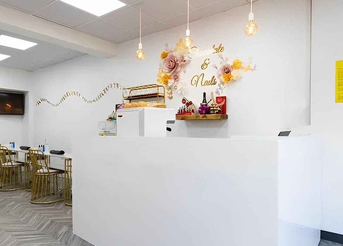 Reception area of Chocolate & Nails - Northfield in London, England, GB, featuring chic decor and modern seating.