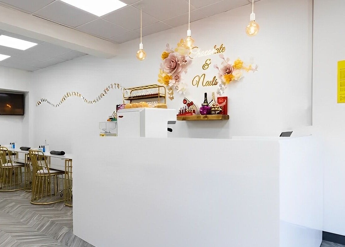 Reception area of Chocolate & Nails - Northfield in London, England, GB, featuring chic decor and modern seating.