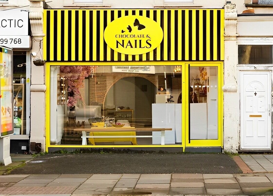 Front view of Chocolate & Nails - Northfield, London, England, GB with bright yellow signage and inviting entrance.