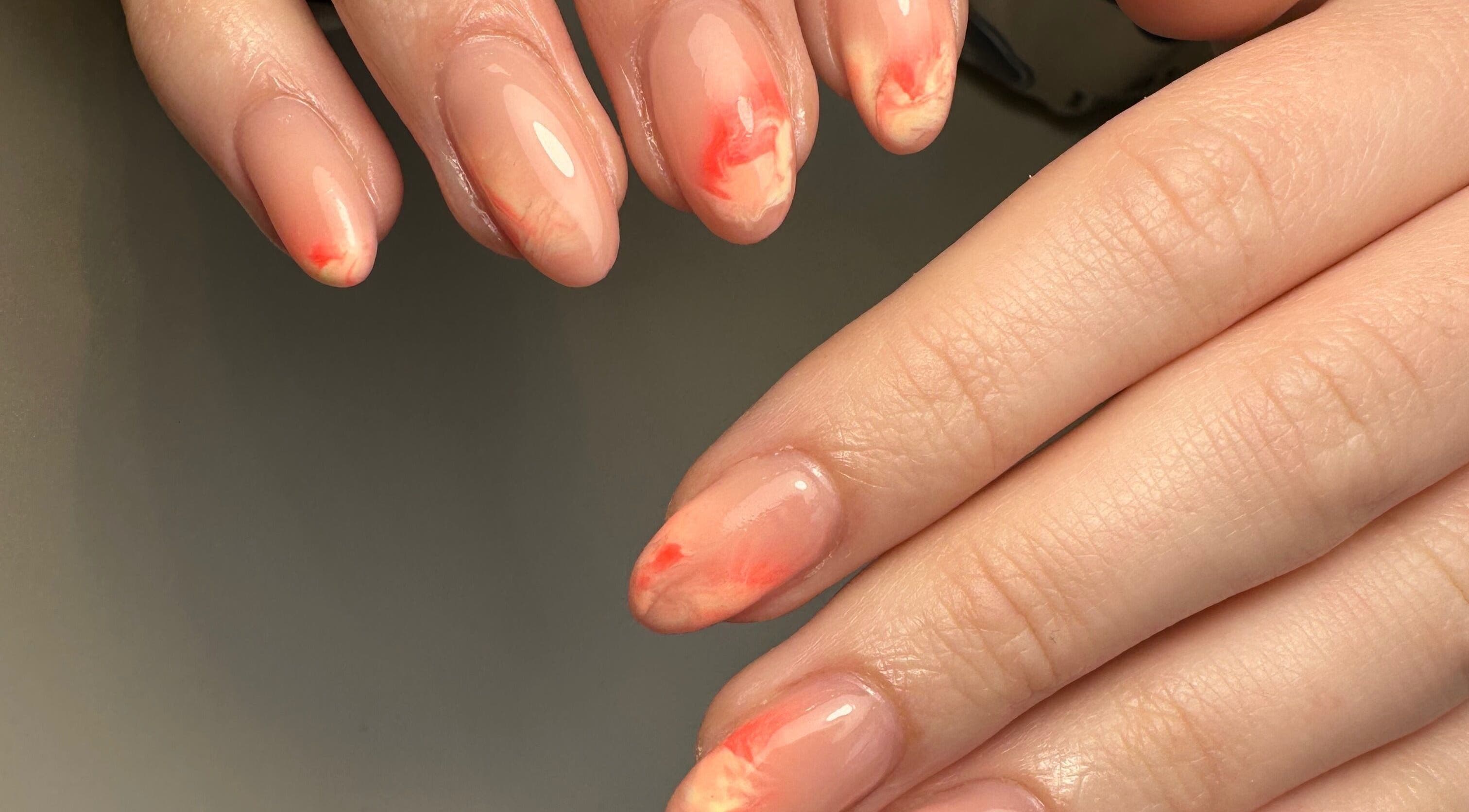 Elegant coral ombre nails from Pink Studios, Middlesbrough, England, GB, showcasing expert manicure.