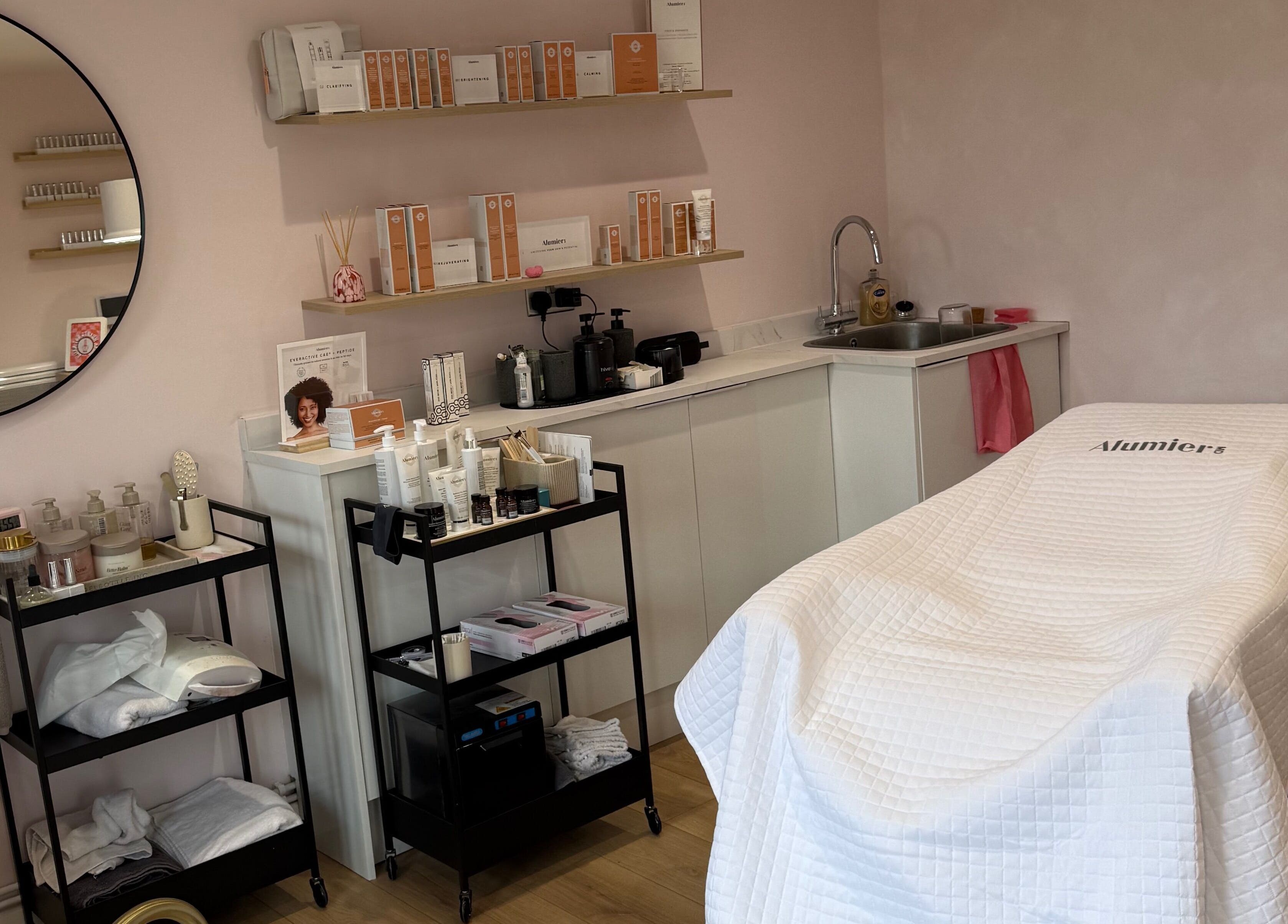 Calm treatment room at Pink Studios, Middlesbrough, England, GB, featuring spa essentials and comfortable therapy bed.