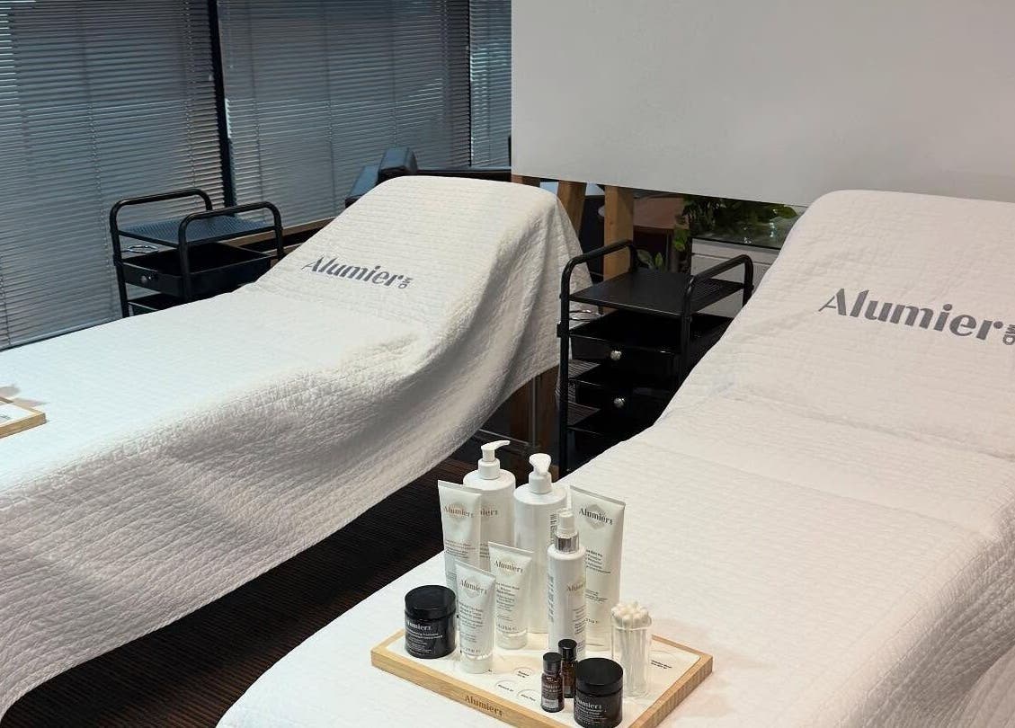 Two treatment beds at Pink Studios, Middlesbrough, England, GB, with AlumierMD products on display.