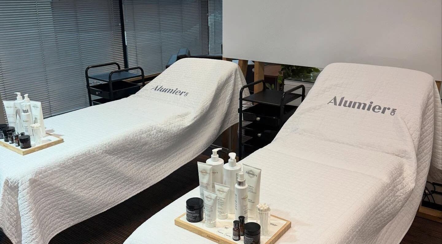 Two treatment beds at Pink Studios, Middlesbrough, England, GB, with AlumierMD products on display.