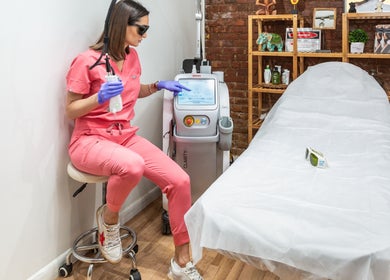 Laser technician at Écou's Laser Boutique in Scottsdale, Arizona, US, preparing a treatment room.